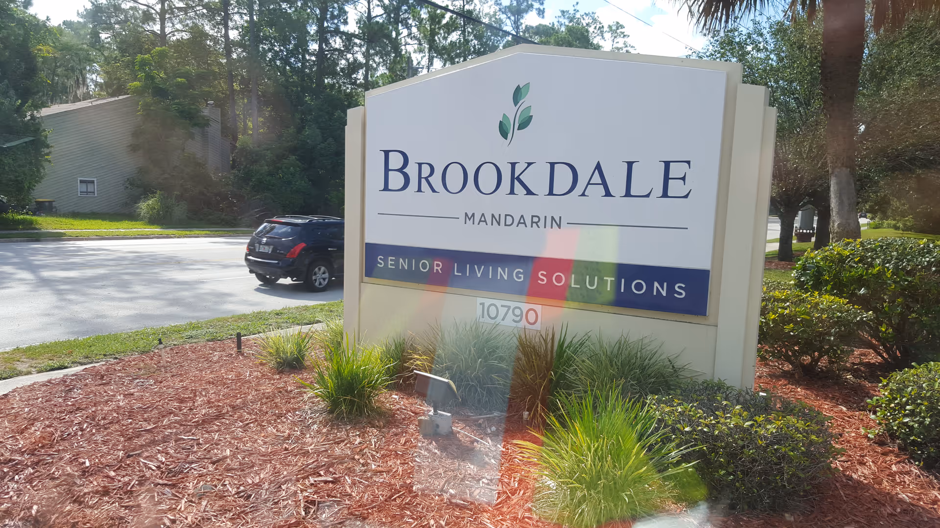Exterior view of Brookdale Mandarin sign with landscaping in front of the facility.