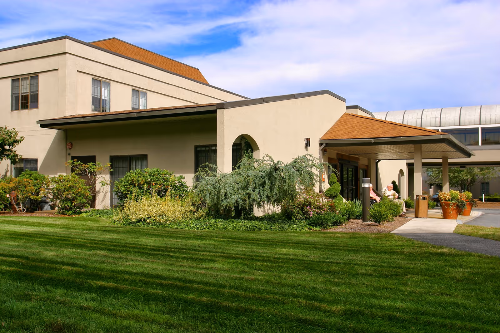 Exterior view shows Beaumont Rehab & Skilled Nursing Center Westboro with lawn and a covered entrance.
