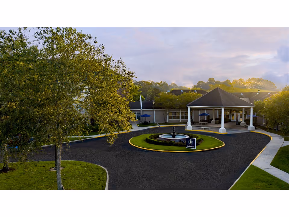 A circular driveway with a fountain surrounds the front entrance of Young's Care Home II.