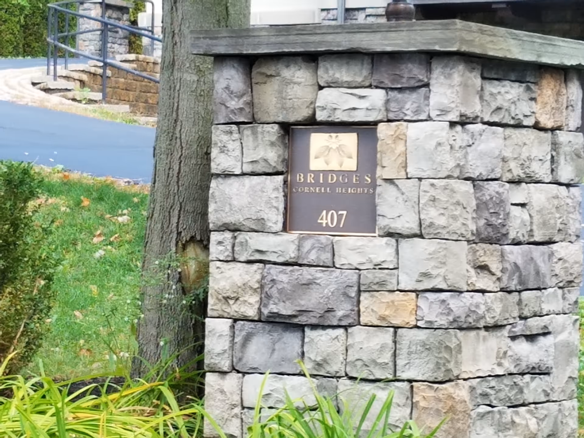 Stone pillar sign for Bridges Cornell Heights, address 407, at entrance.