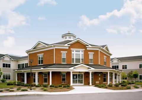The Pines Machias Campus senior living facility exterior with brick facade and landscaped entrance.