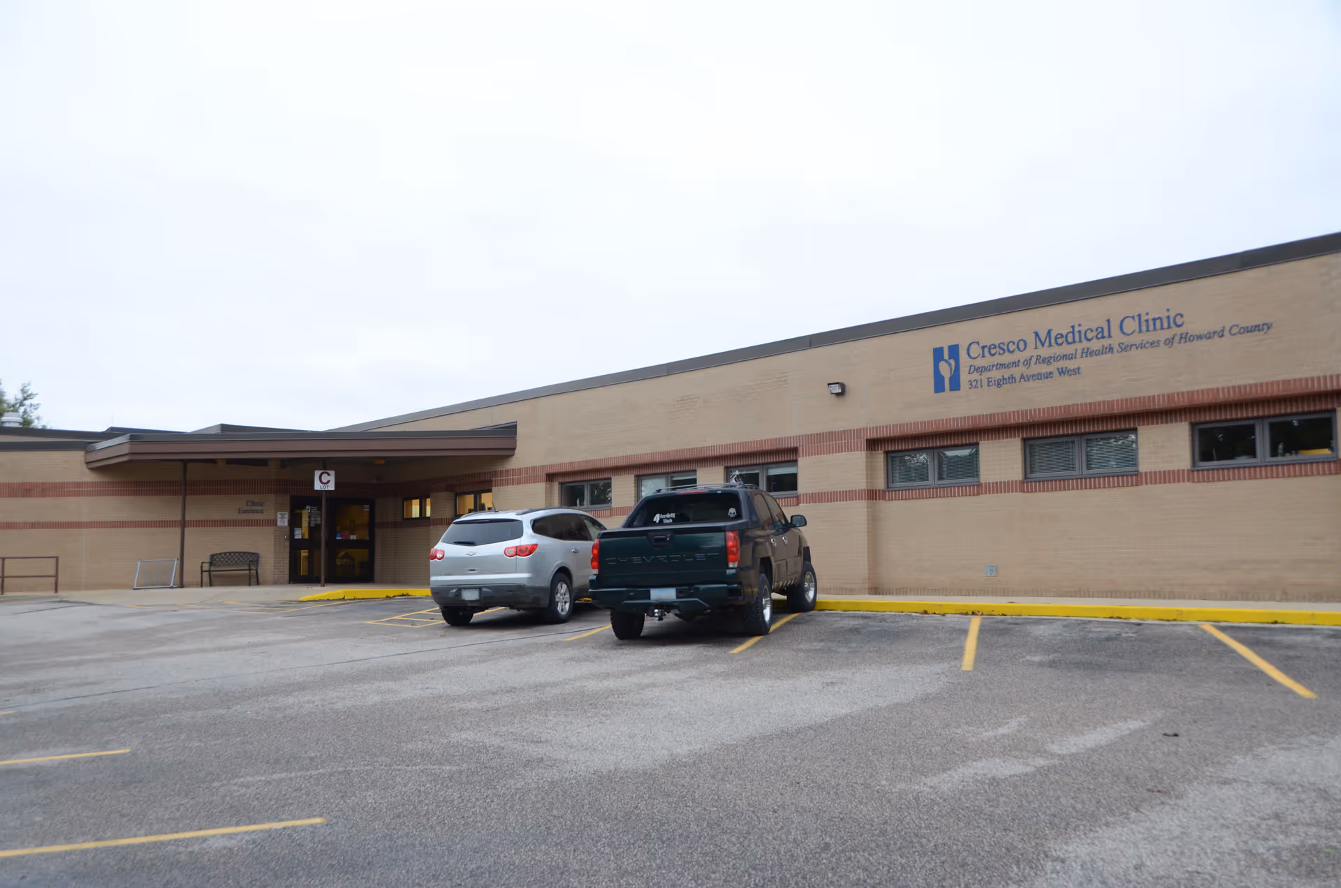 Exterior view of Cresco Medical Clinic with a parking lot in front.