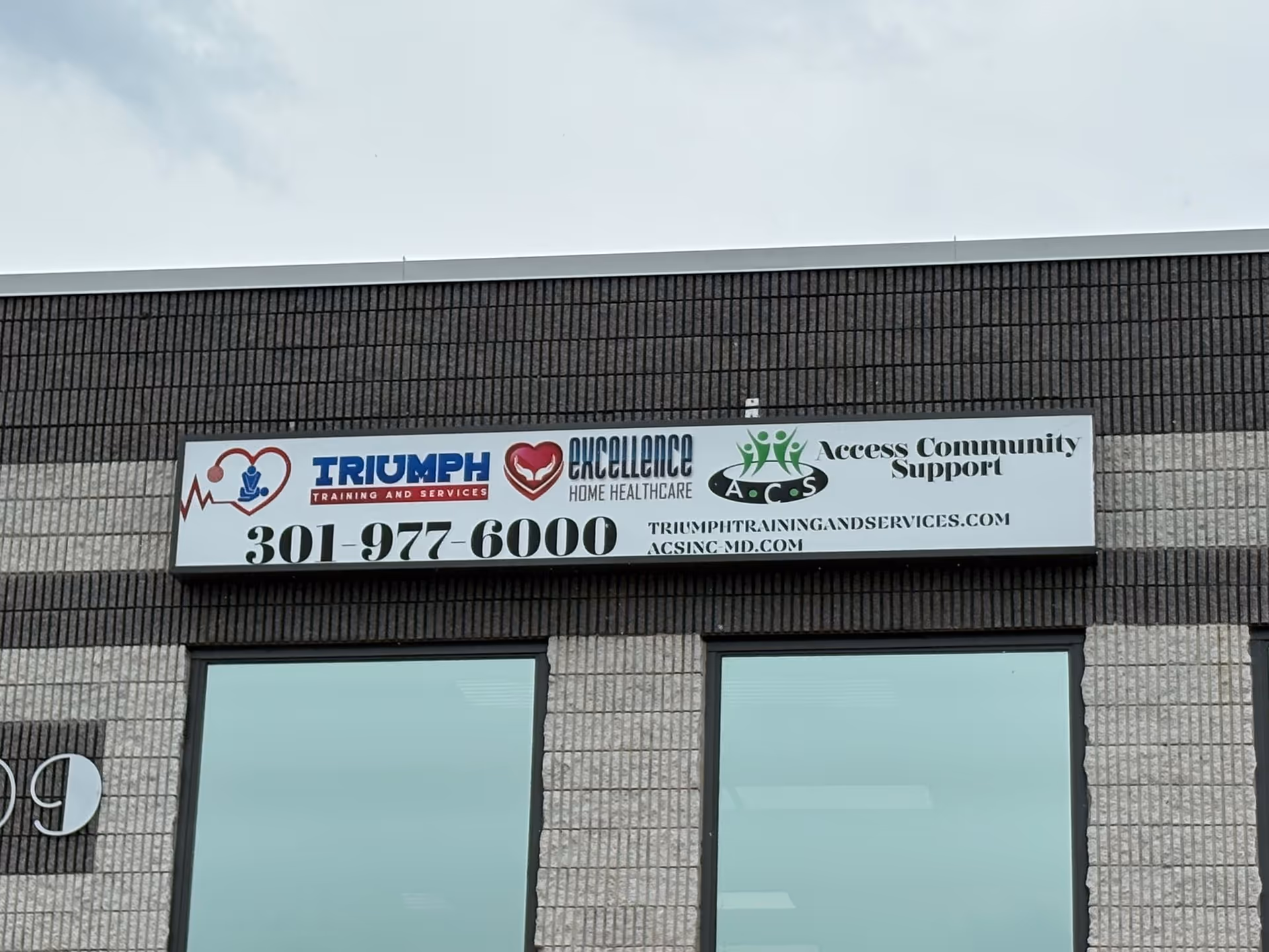 Exterior of a brick building with a sign for Excellence Home Healthcare