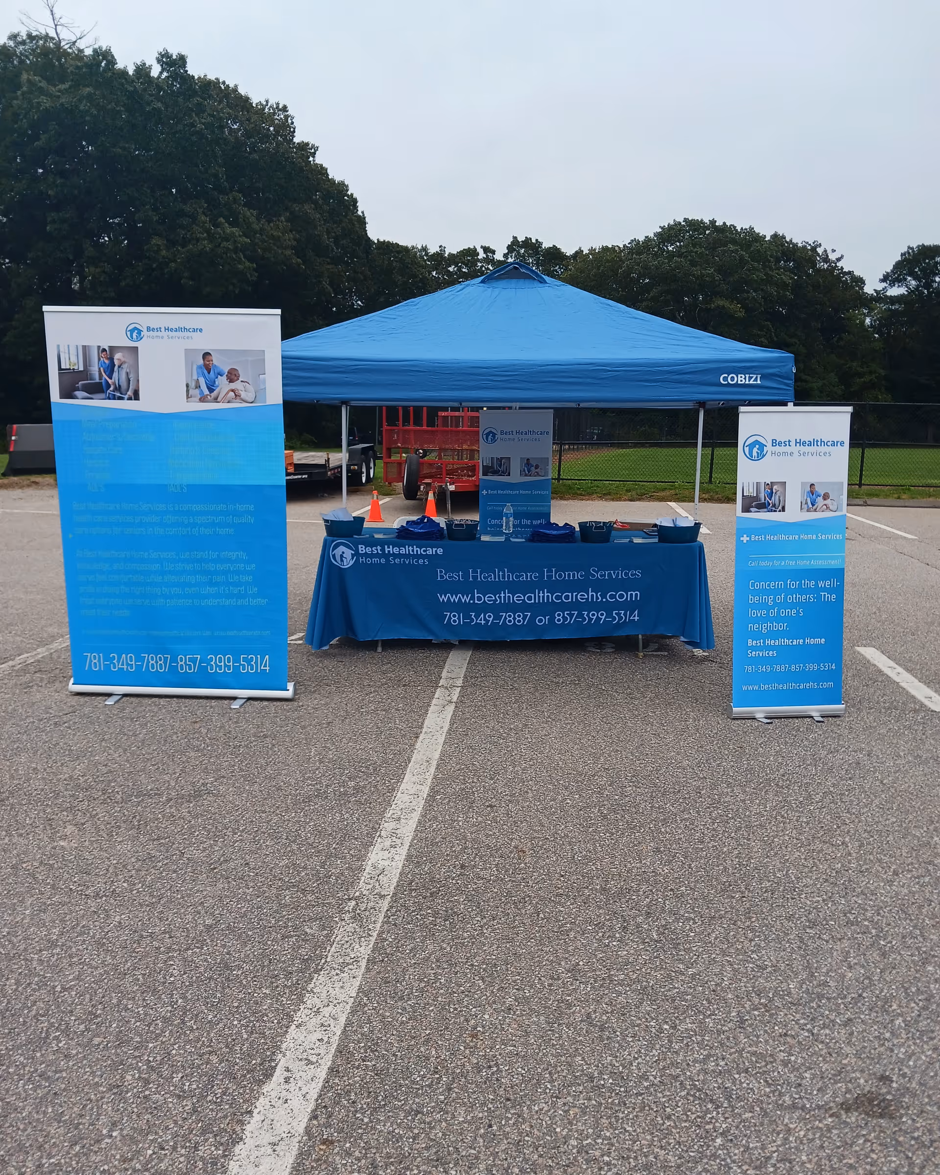 Outdoor promotional booth for Best Healthcare Home Services with a blue canopy tent and banners.