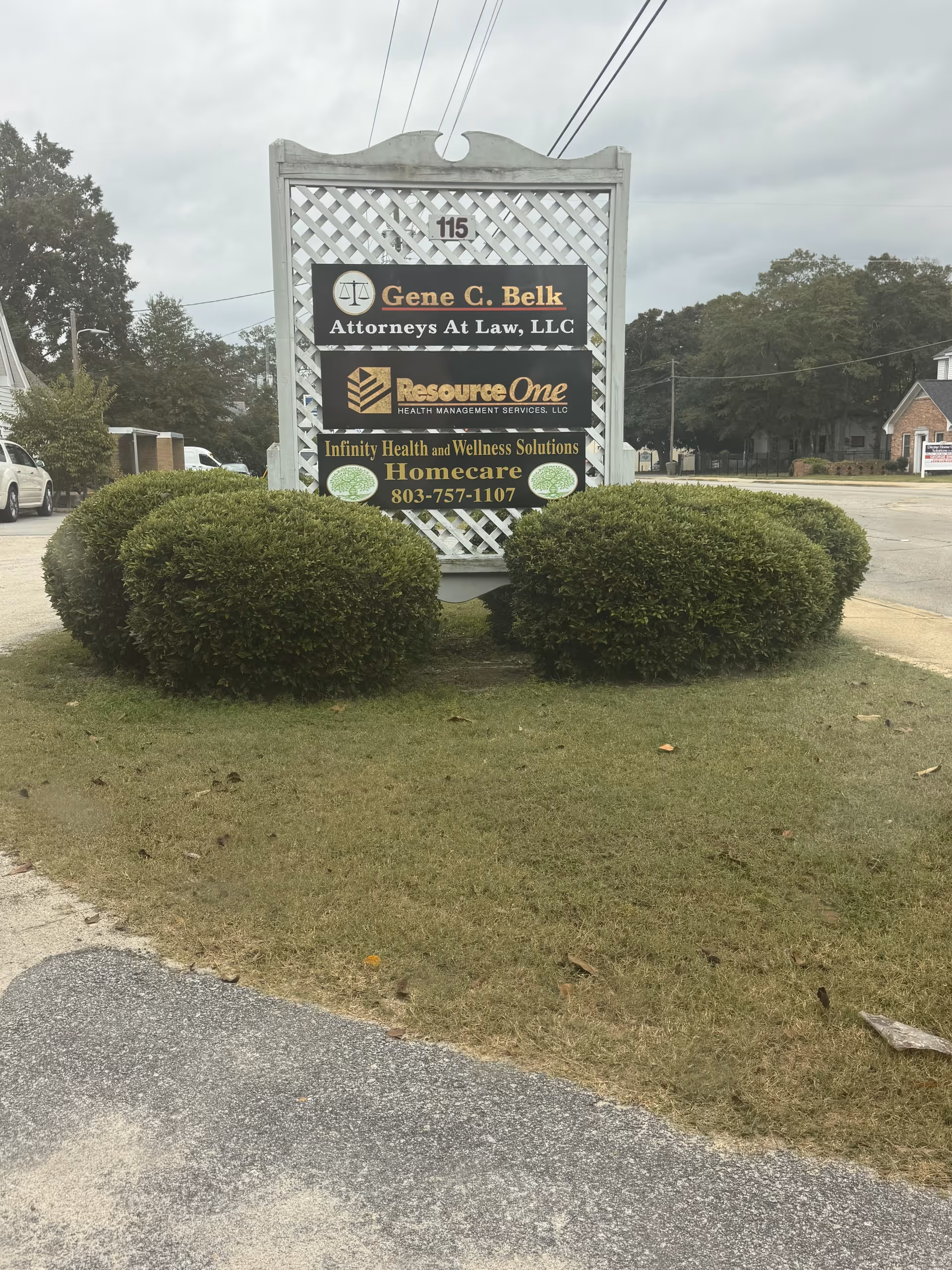 Freestanding outdoor sign displaying Infinity Health and Wellness Solutions among other business signs.
