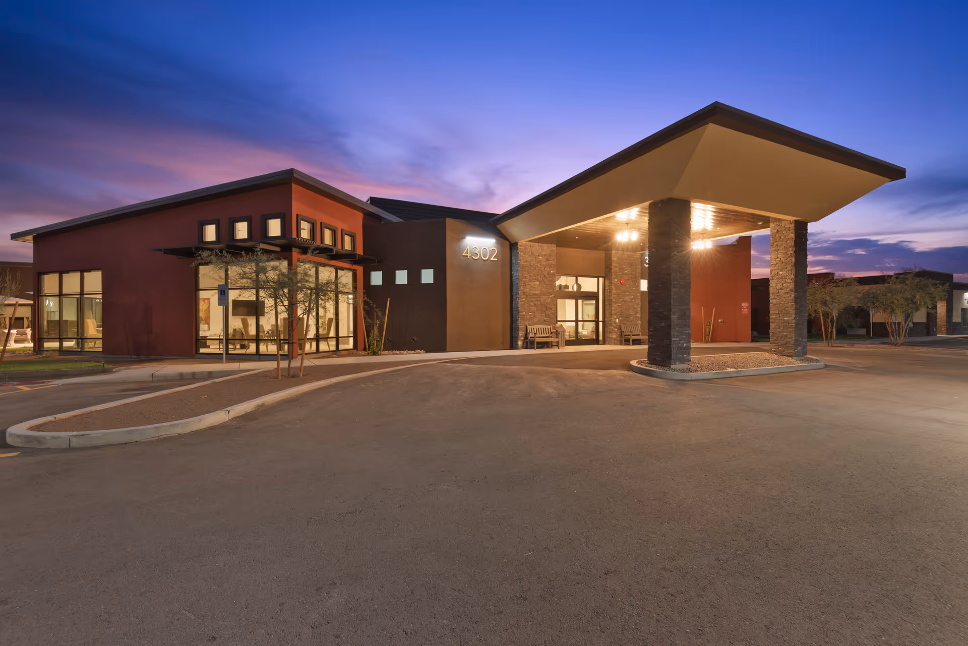 Exterior view of Cave Creek Assisted Living entrance at dusk.