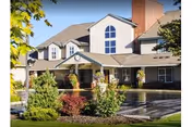 Front exterior of Highgate Senior Living Yakima, showing the entrance and manicured landscaping.