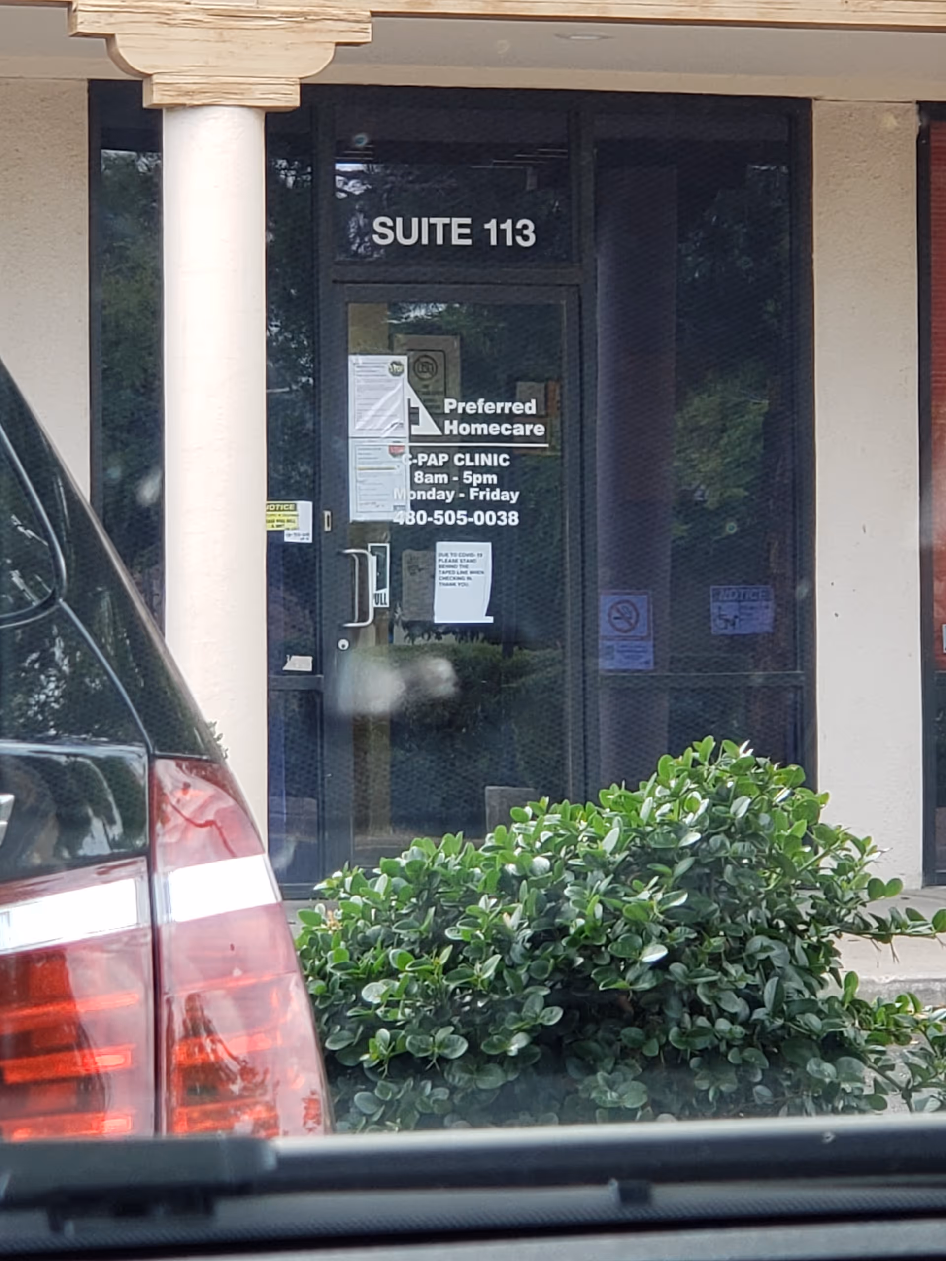 Front entrance of a building showing Suite 113 and Preferred Homecare signage