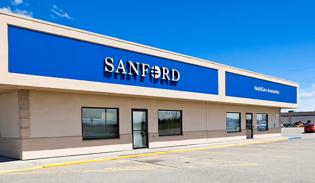 Front exterior of a Sanford clinic with blue signage and windows.