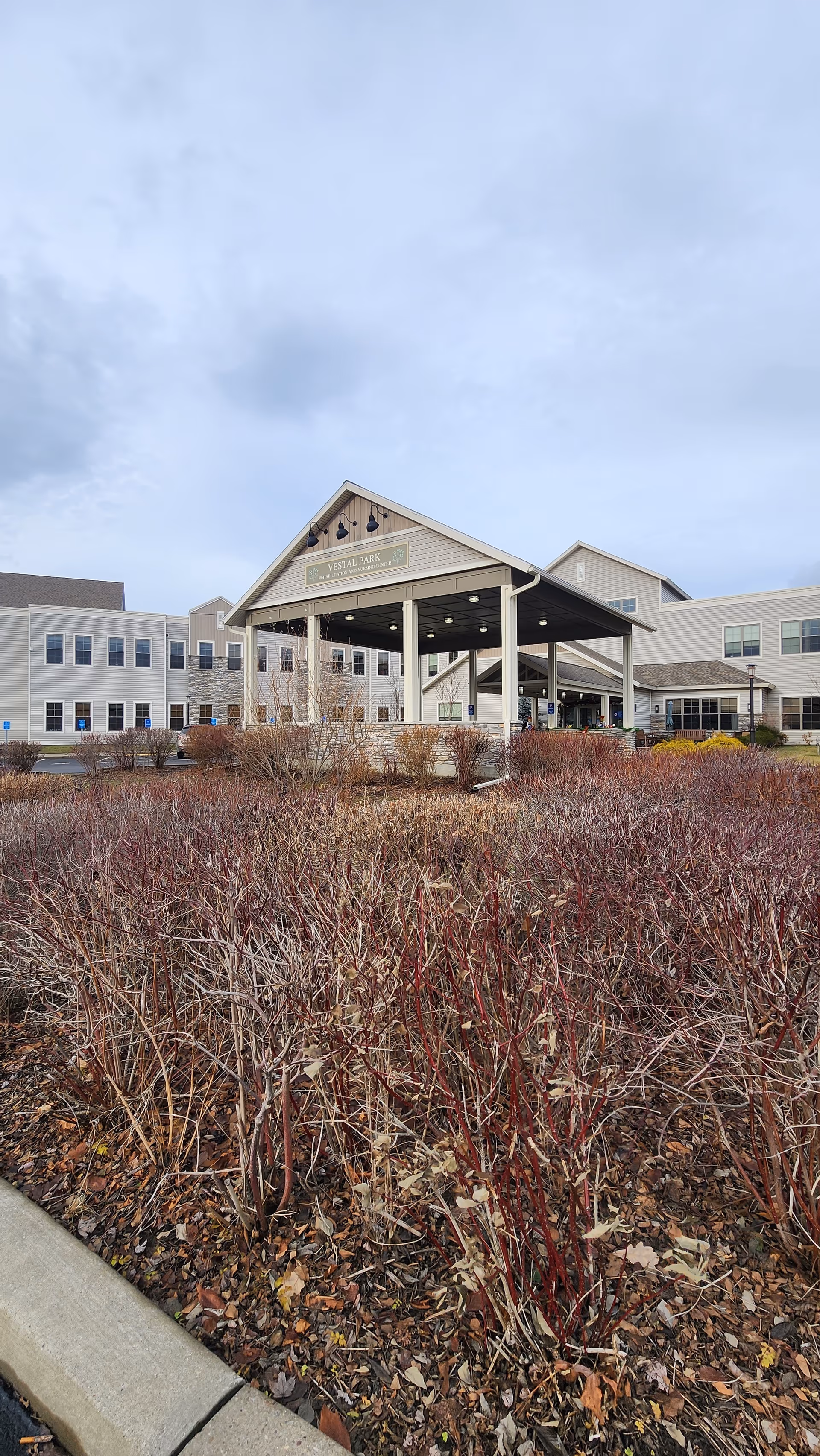 Exterior view of Vestal Park Rehabilitation and Nursing Center entrance with a covered drop-off.