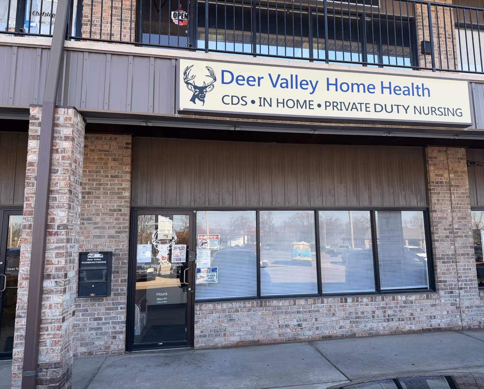 Exterior storefront of Deer Valley Home Health Services LLC with brick facade and sign.