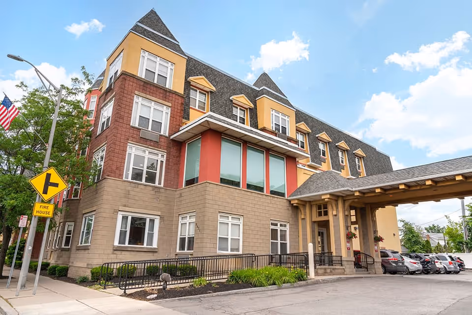 Exterior view of Brookdale Kenmore, a senior living building with colorful facade and covered entrance.