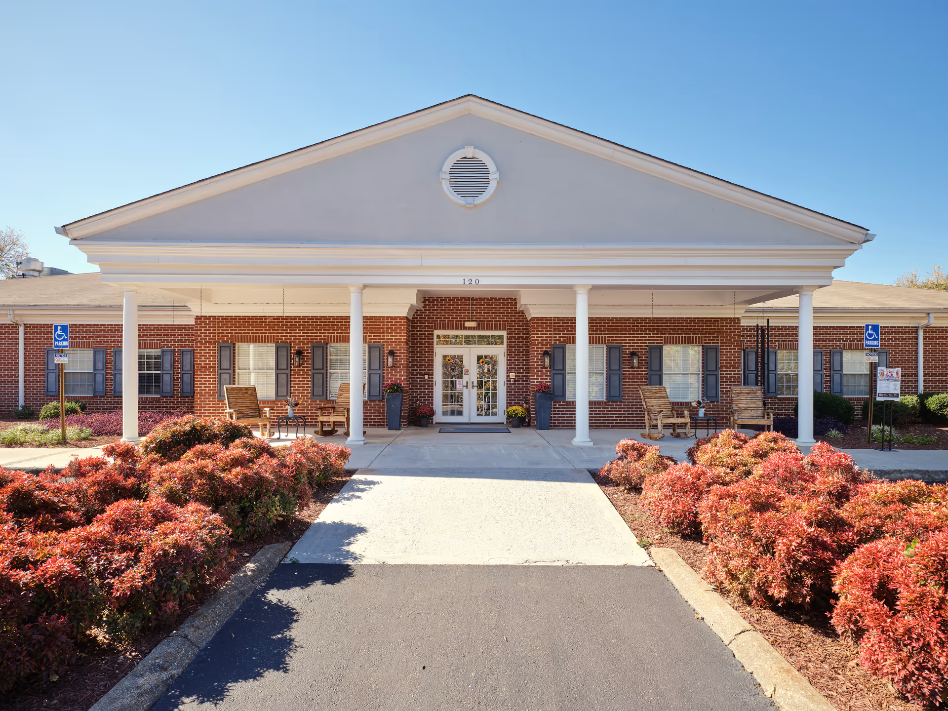TerraBella Athens entrance with brick building, white columns, and a covered front porch.