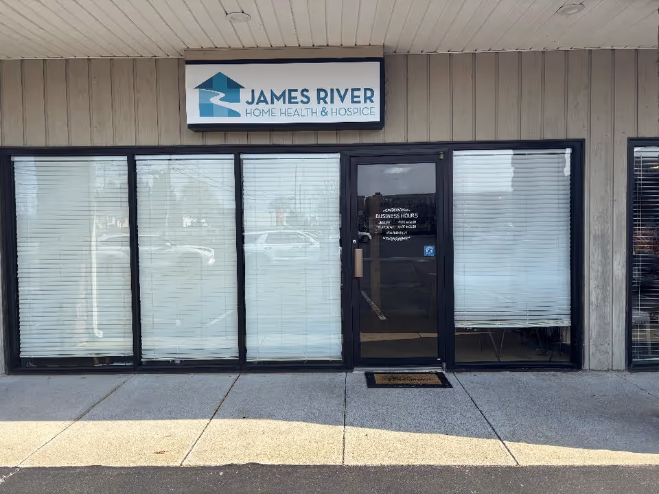 Front exterior of James River Home Health & Hospice storefront with glass doors and blinds.