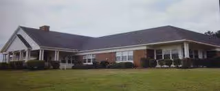 El Camino House senior living facility, a single-story brick building with manicured lawn.