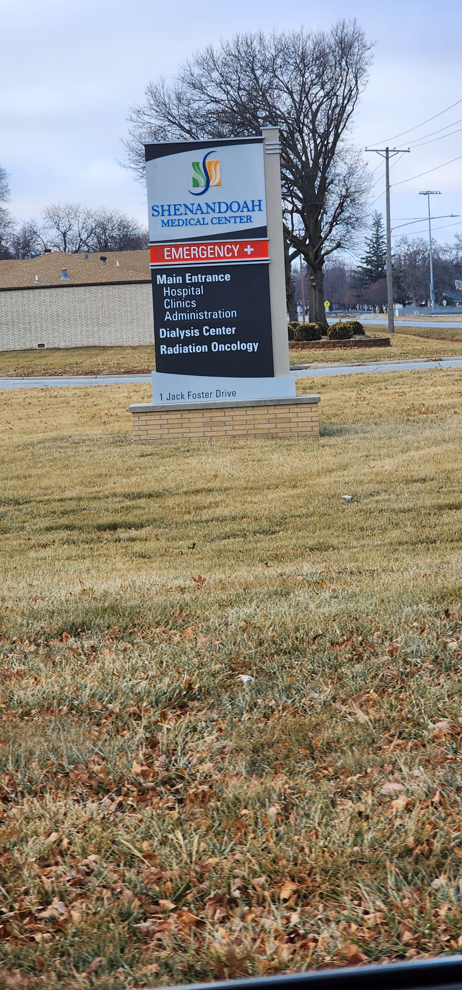 A tall Shenandoah Medical Center sign on a grassy lawn with surrounding trees.