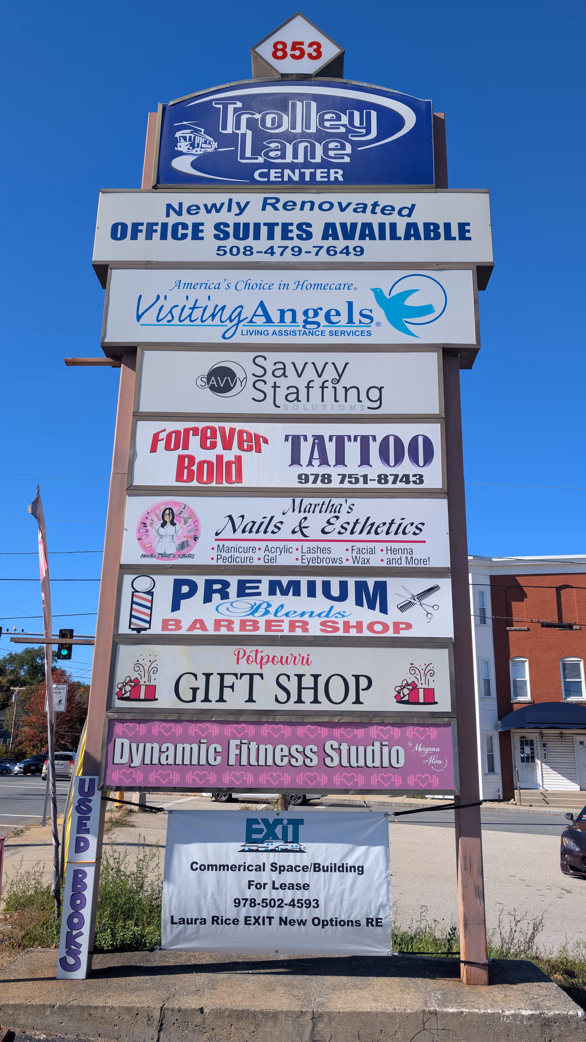 Tall outdoor signboard listing multiple businesses, including Visiting Angels Senior Home Care.