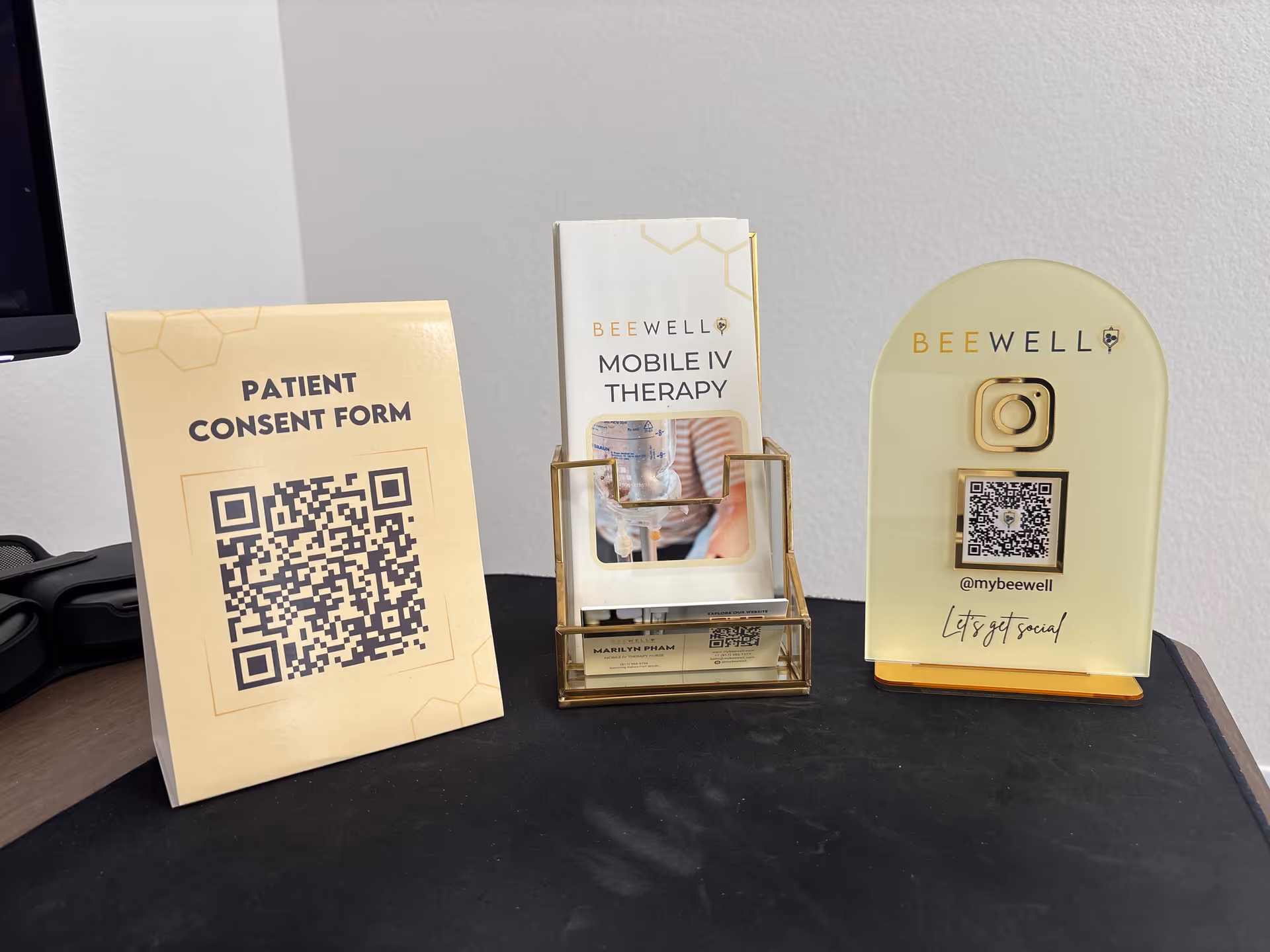 Desk with patient consent form and Bee Well Mobile IV Therapy brochures