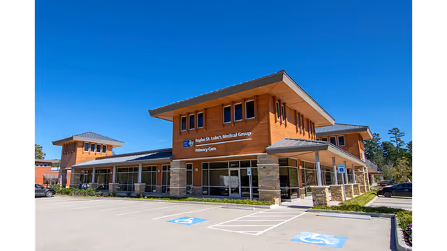 Modern medical facility with signage and accessible parking spaces in the foreground.