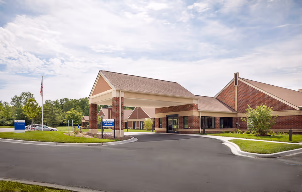 Exterior view of Pomeroy Living Sterling Skilled Rehabilitation facility with brick building and entry canopy.