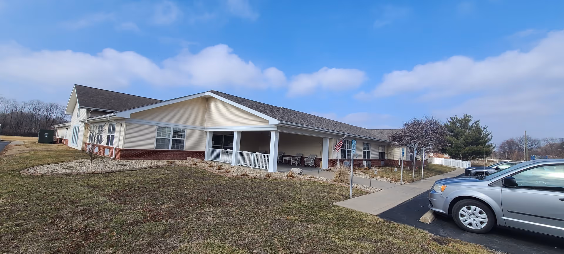 Exterior view of Oakview Villa senior living facility with a covered porch and parked cars.