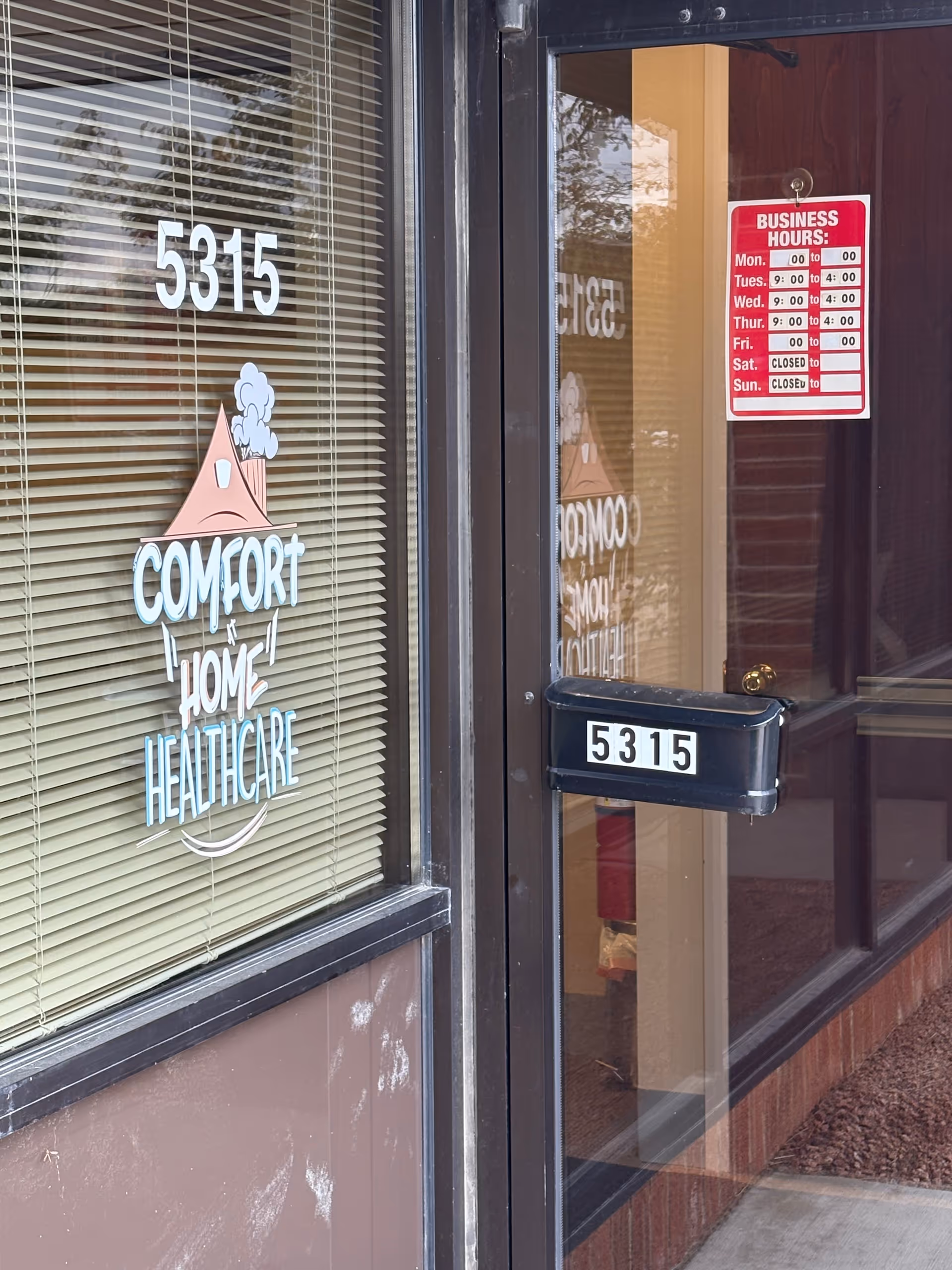 Exterior view of Comfort at Home Healthcare entrance with logo, blinds, and address 5315.
