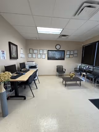 Small office lobby with computer desks and a seating area.
