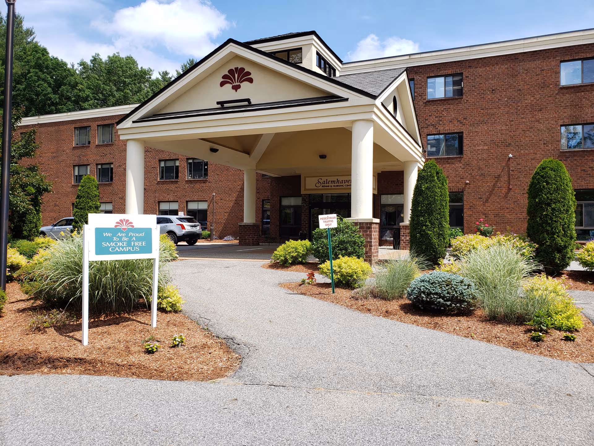Senior living facility Salemhaven entrance with brick building and landscaped front yard.