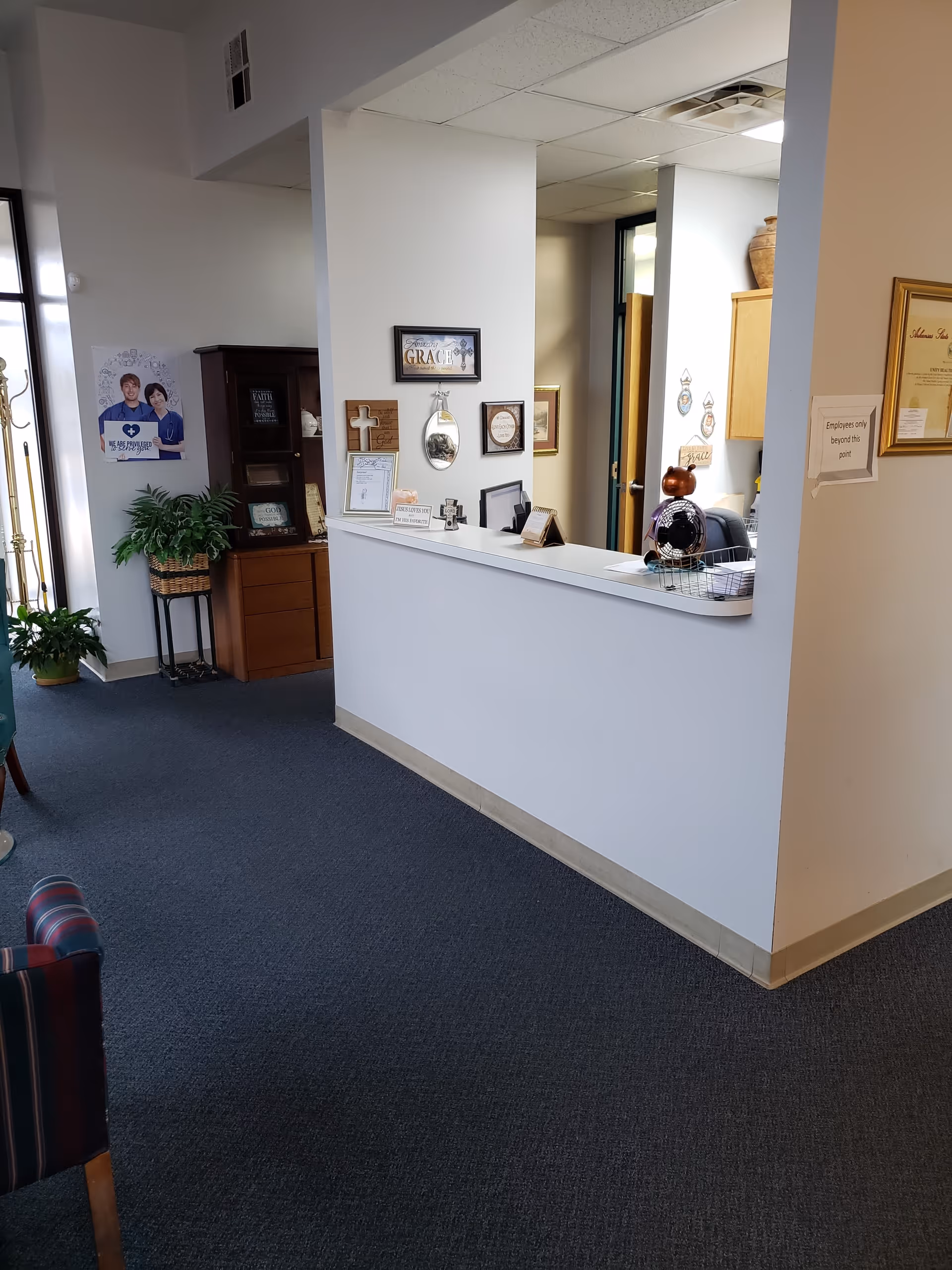 Reception desk and waiting area visible in a senior living facility lobby.