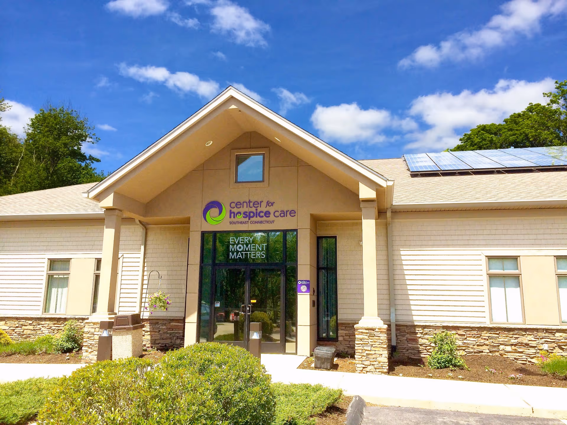 Exterior view of Center for Hospice Care building with entrance and landscaping.