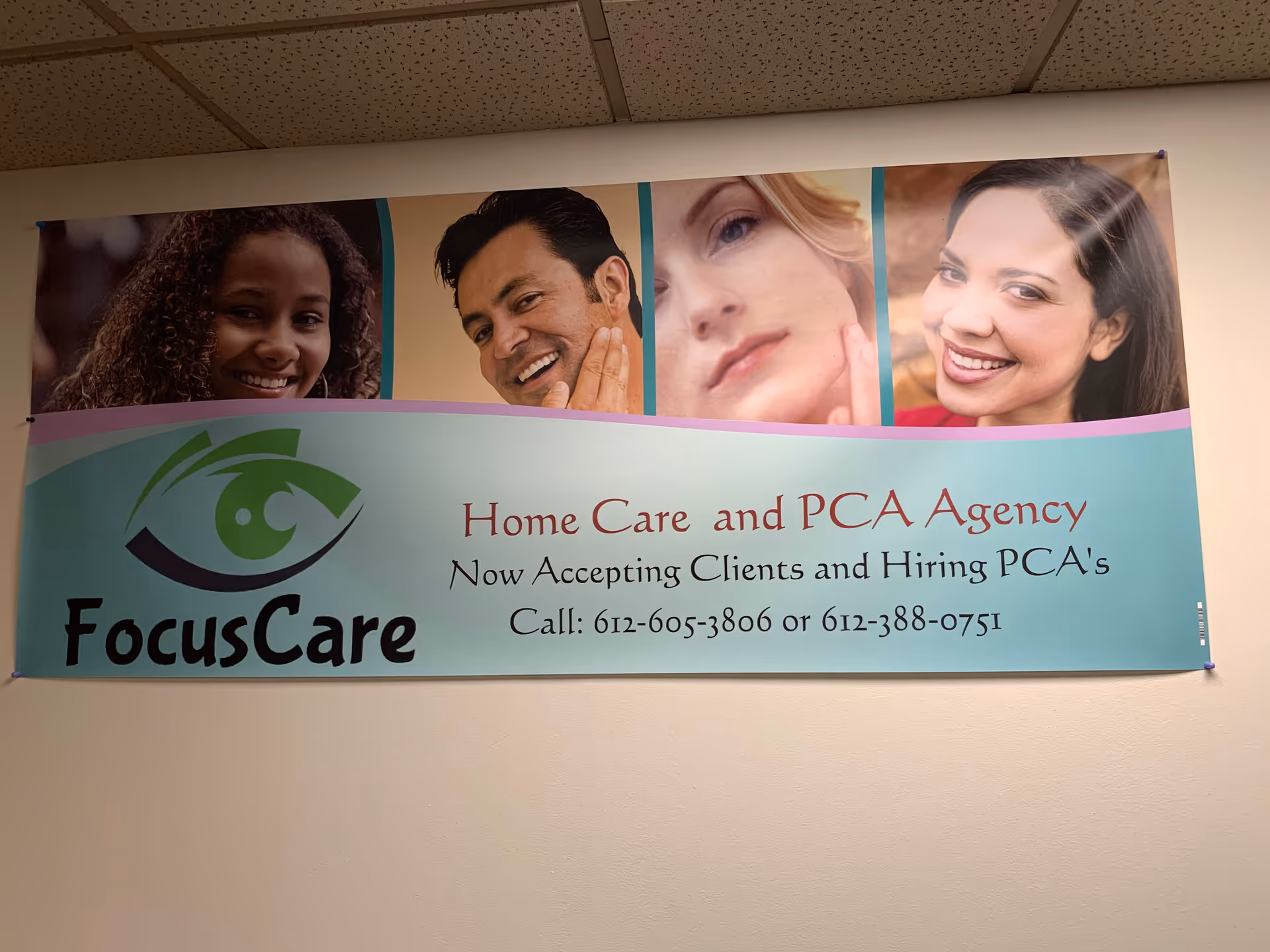 Indoor hallway with a large FocusCare banner featuring smiling faces and text.