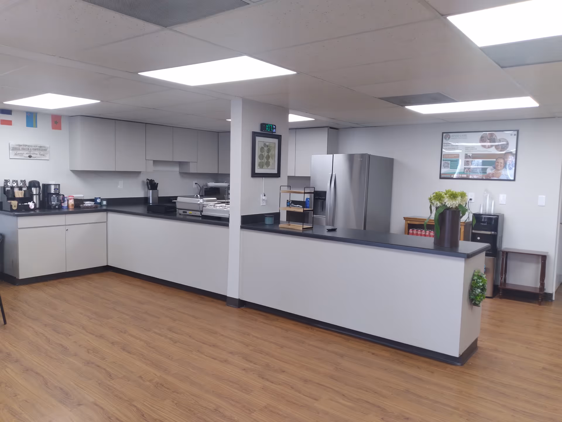Clean kitchen area with a coffee station, counter workspace, and stainless appliances.