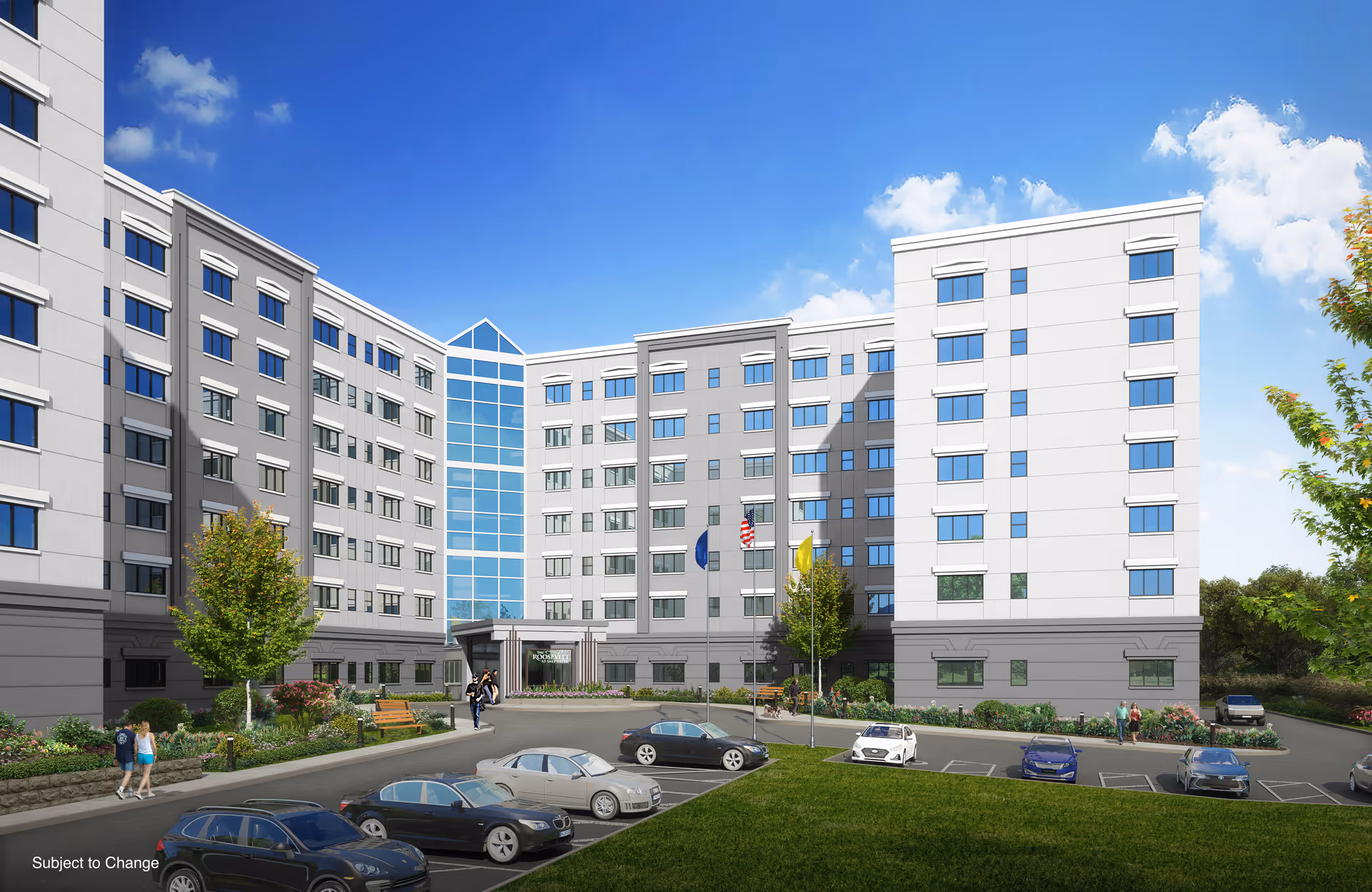 Front exterior of a multi-story senior living building with a landscaped courtyard, flags, parked cars, and a few people walking.