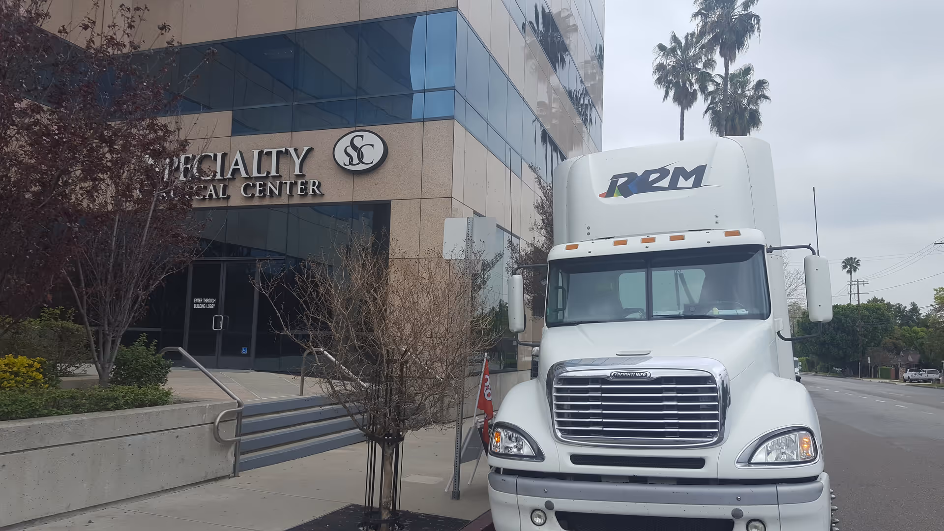 Exterior view of Specialty Surgical Center Encino with a white semi-truck parked on the street.