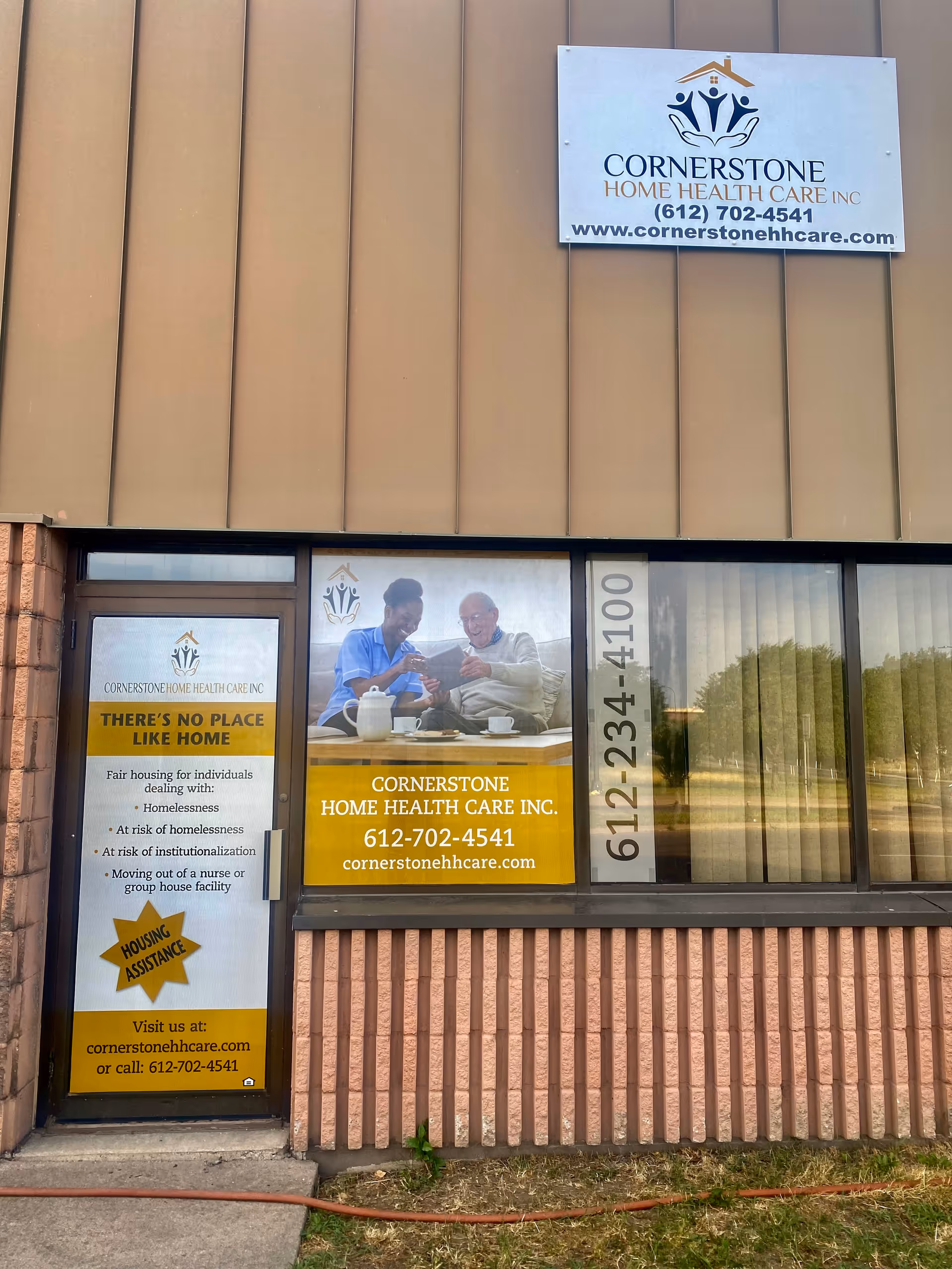 Front of Cornerstone Home Health Care building with signs and posters