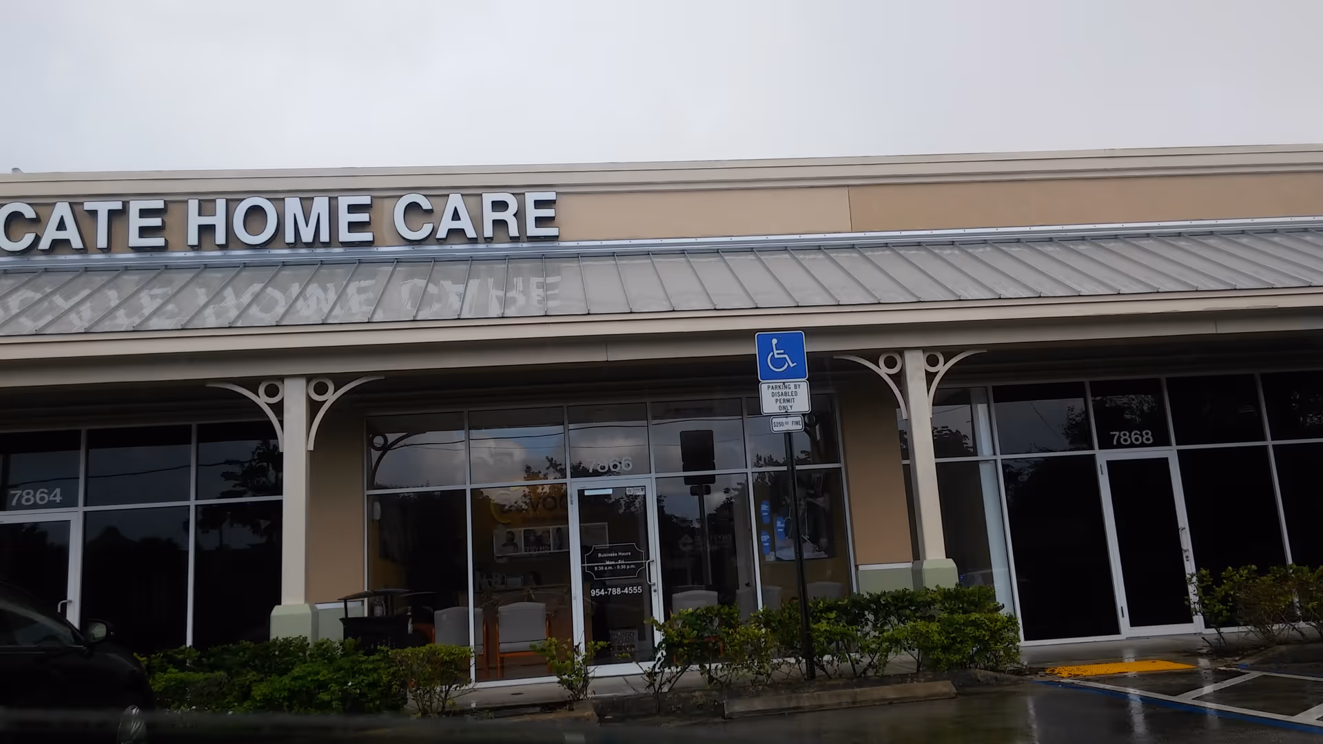 Exterior storefront of Advocate In-Home Care with glass windows and a handicap parking sign.