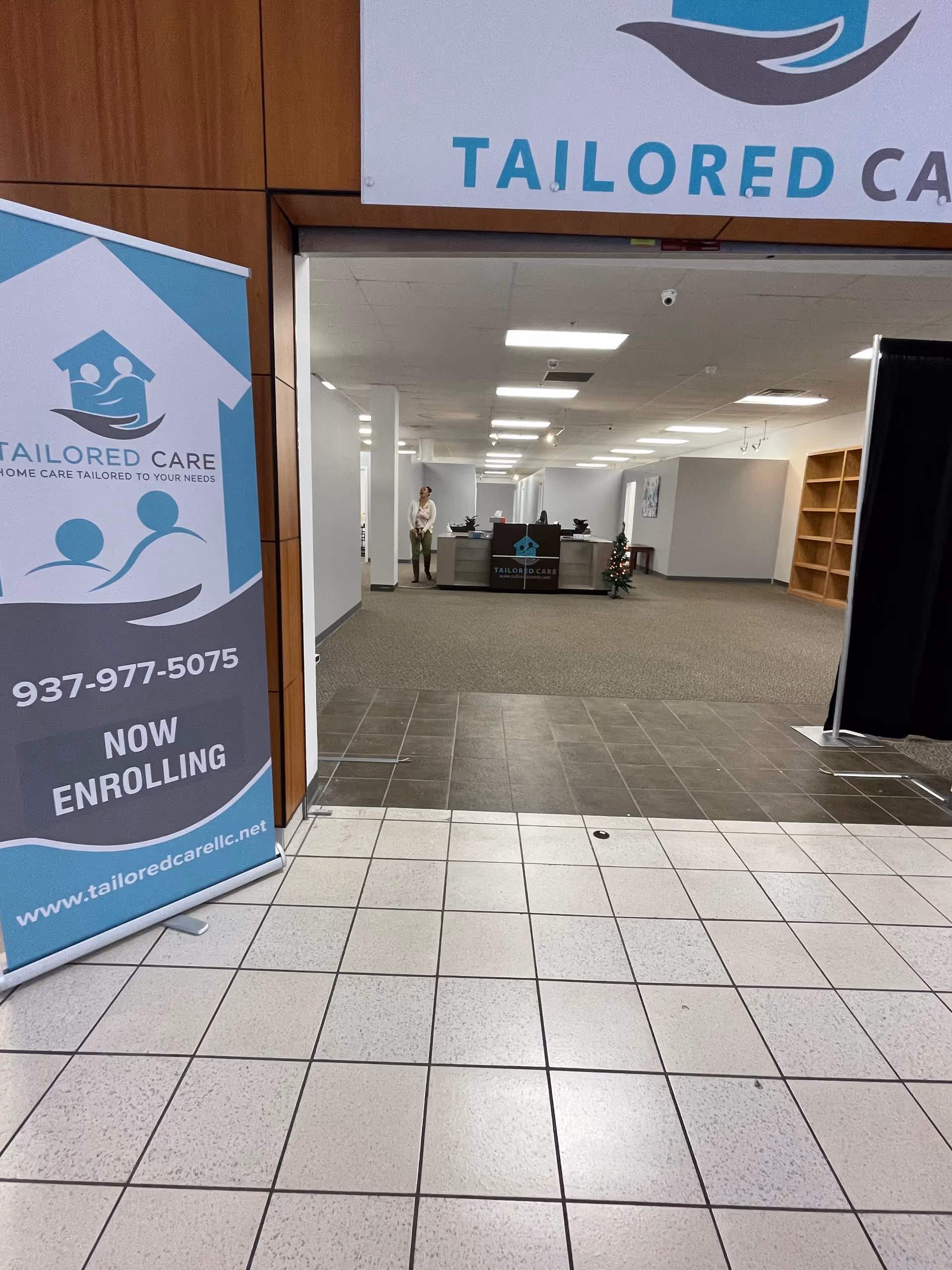 The Tailored Care LLC lobby features banners, a reception desk, and a staff member visible.