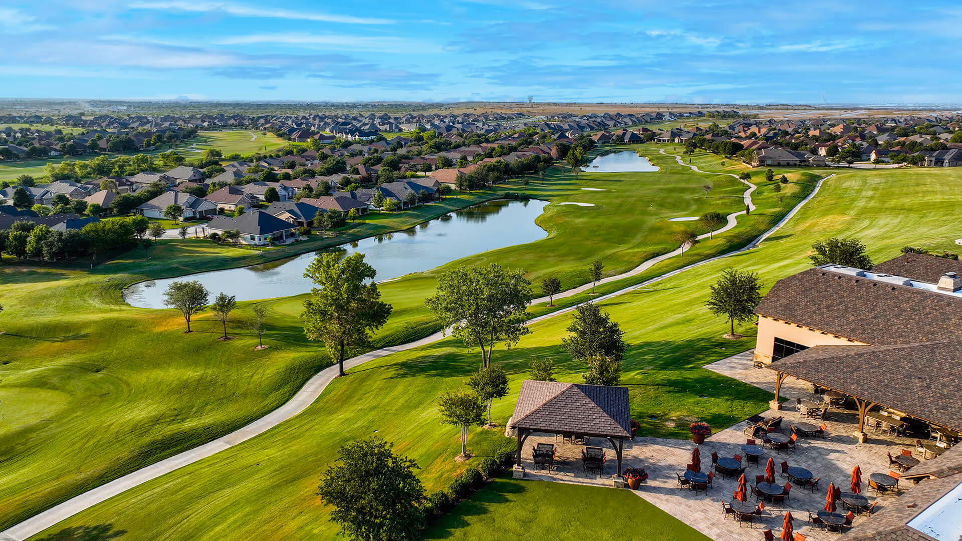 Robson Ranch Texas: outdoor golf course with patio seating near the clubhouse.