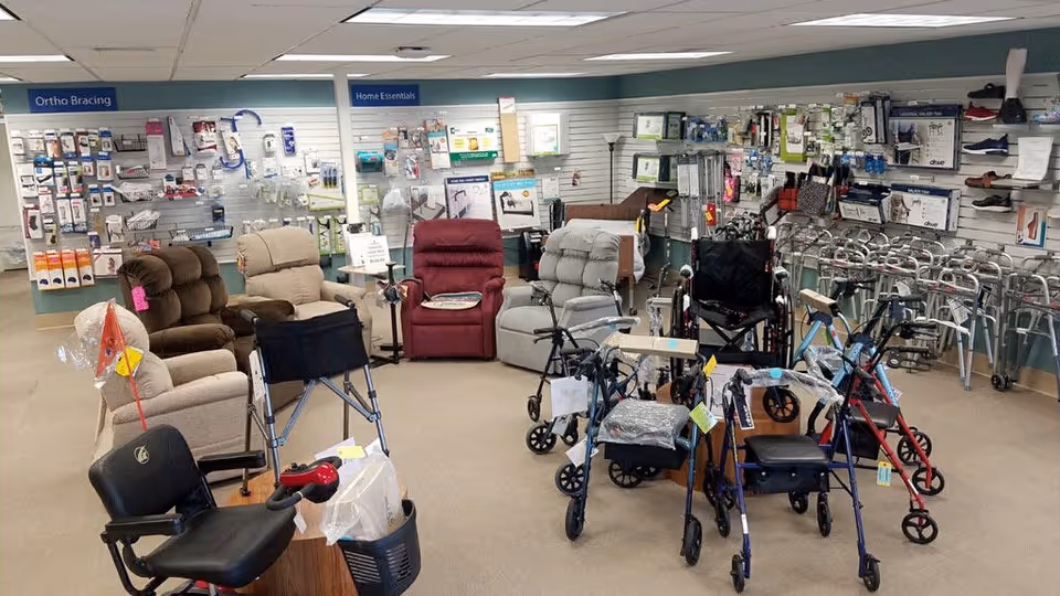 Interior showroom of mobility aids and seating with walkers, lift chairs, and scooters.