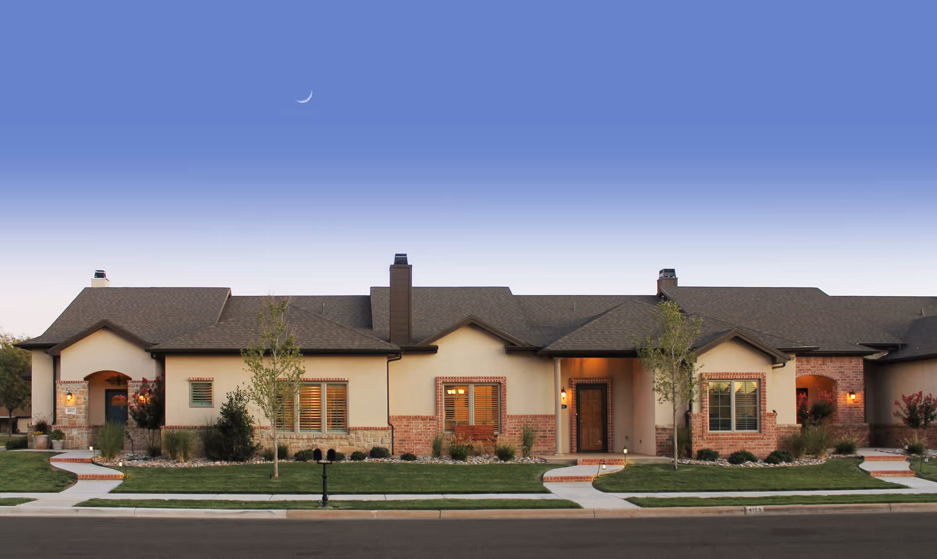 Front exterior of a single-story Carillon senior living building with brick accents and landscaping.