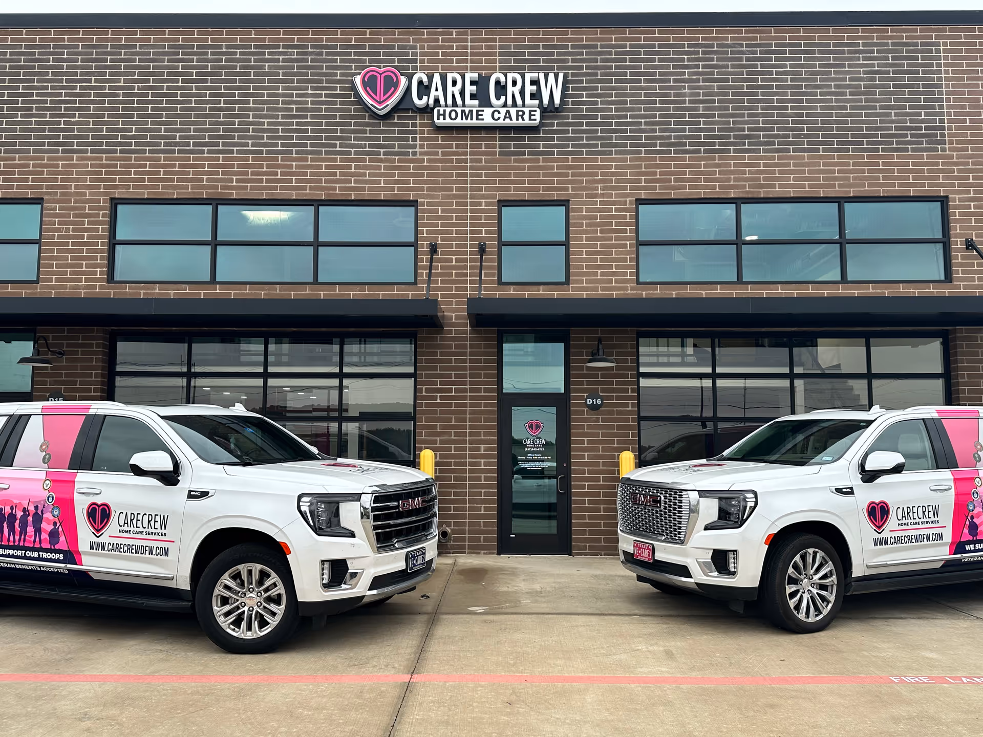 Exterior view of Care Crew Home Care building with two branded trucks parked in front.