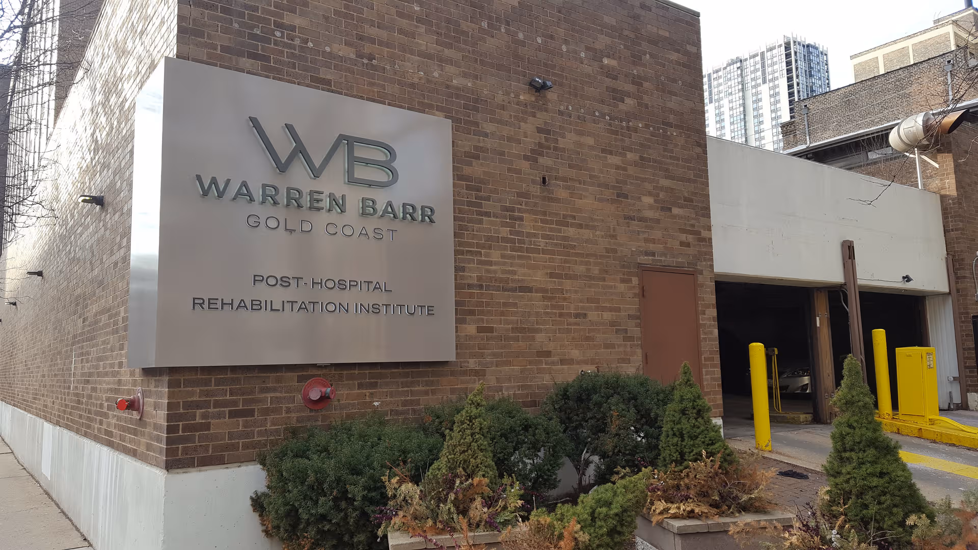 Exterior of brick building with Warren Barr Gold Coast sign and open entry doors.
