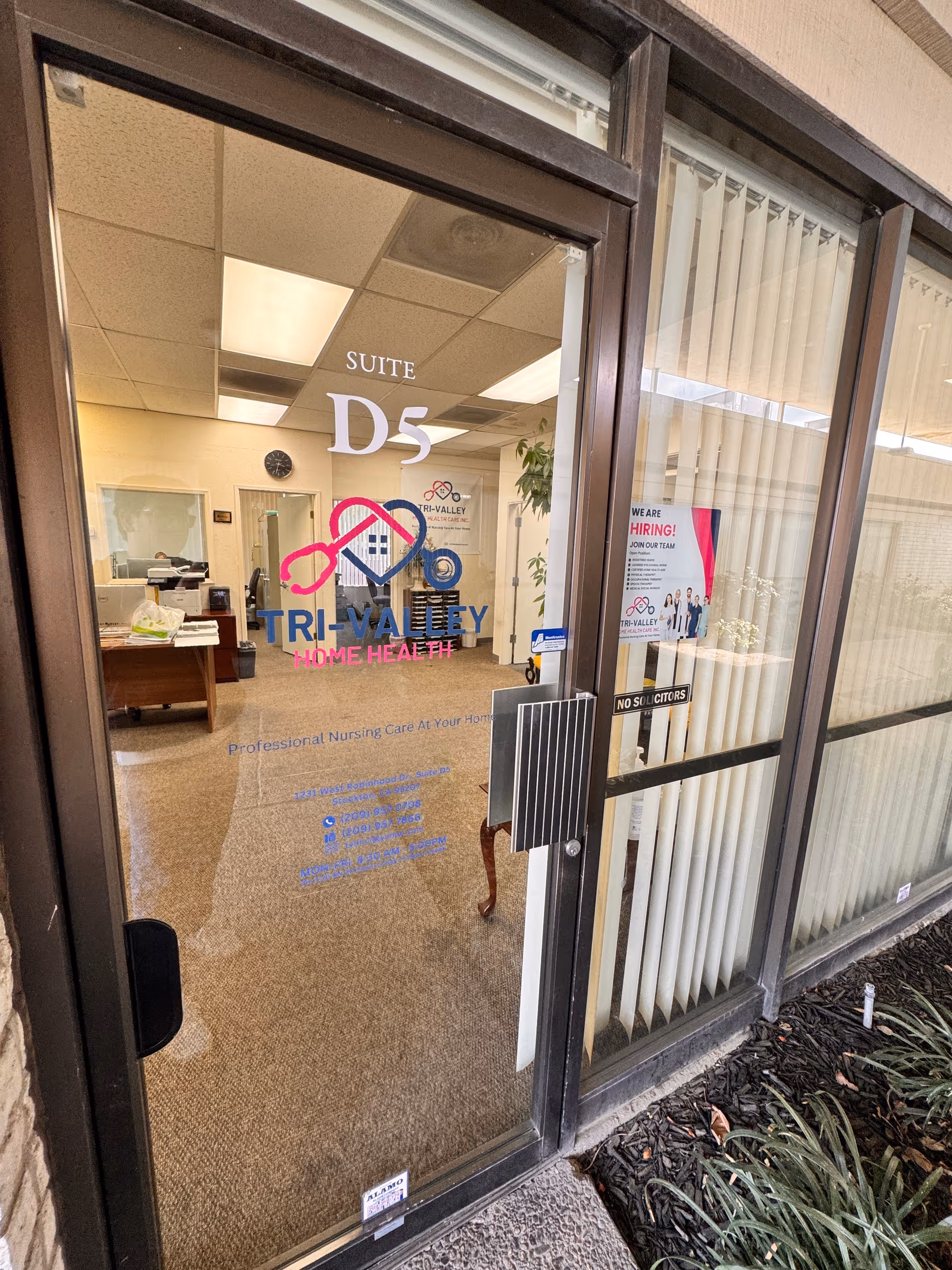 Glass entrance door labeled Suite D5 opens into a reception area.