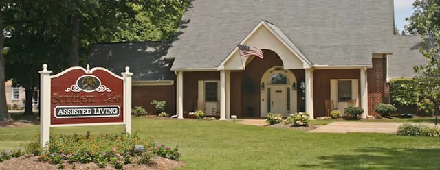Front view of Southern Oaks Assisted Living with entrance, sign, and lawn.