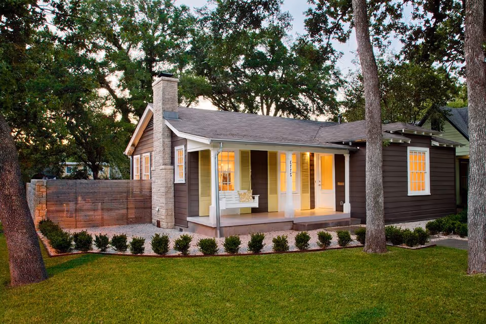 Front view of Creekside HomeCare facility: cozy single-story house with warm porch lights.