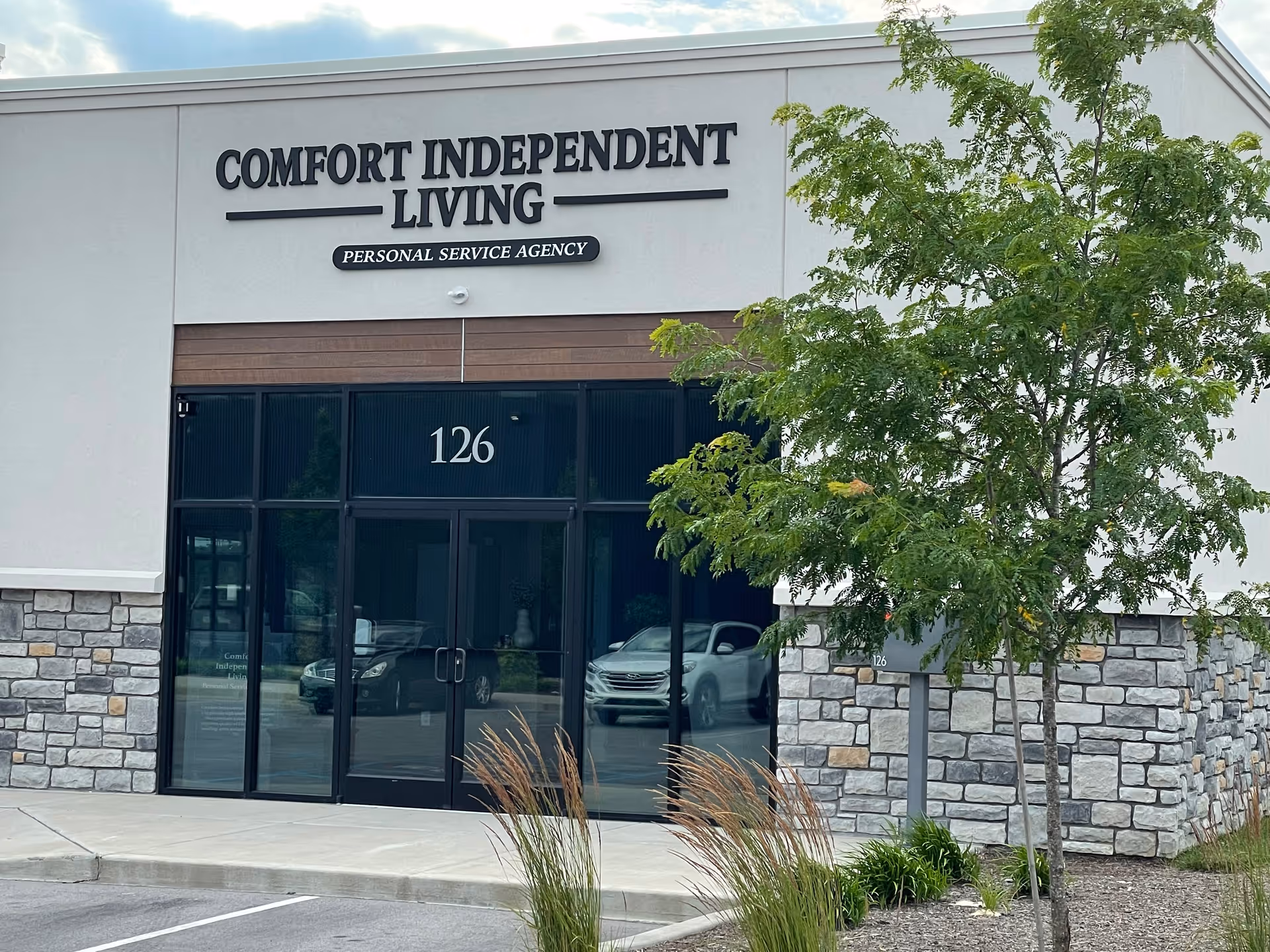 Exterior view of Comfort Independent Living entrance with glass doors.