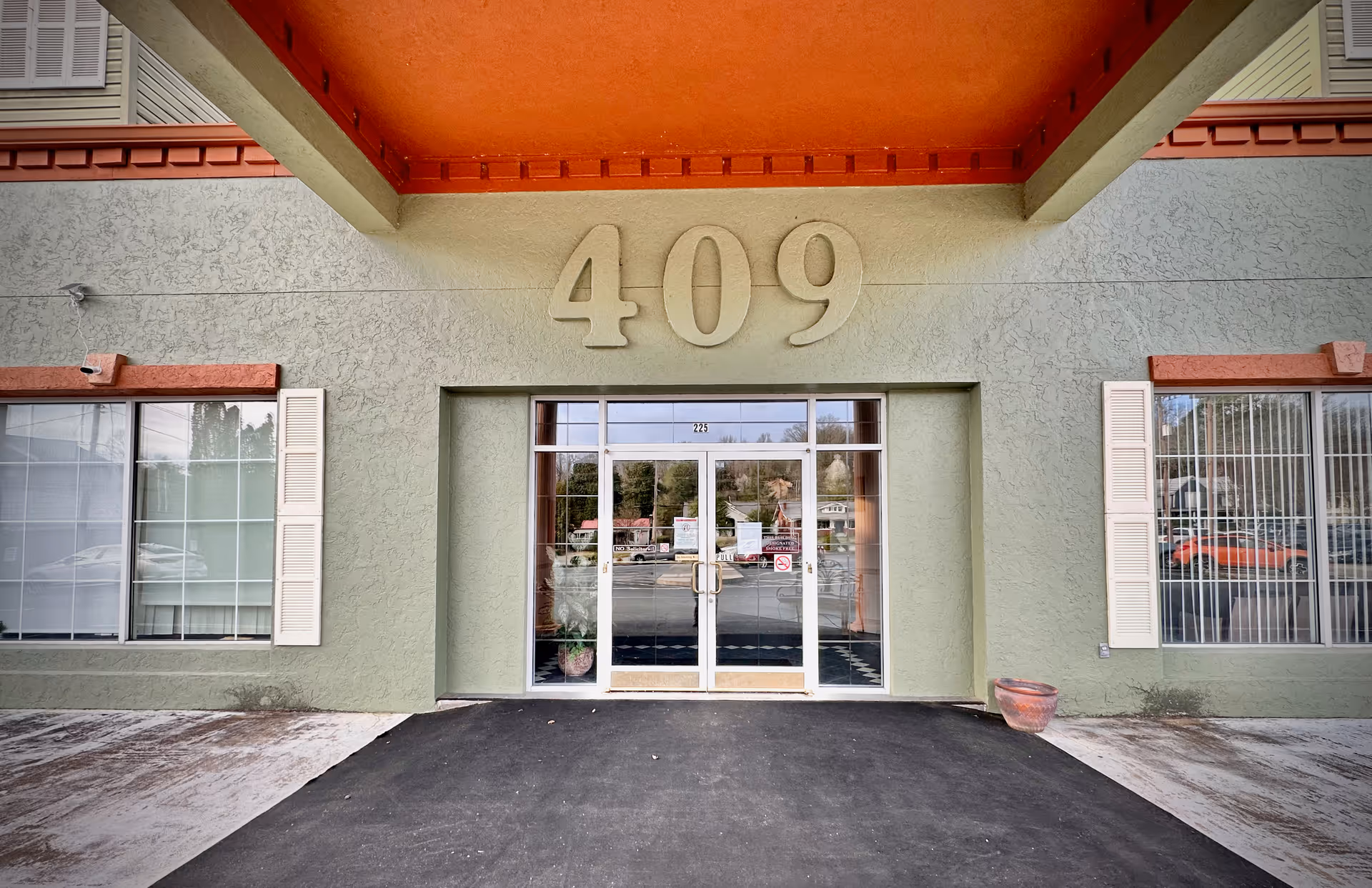 Exterior building entrance with large 409 above glass doors.
