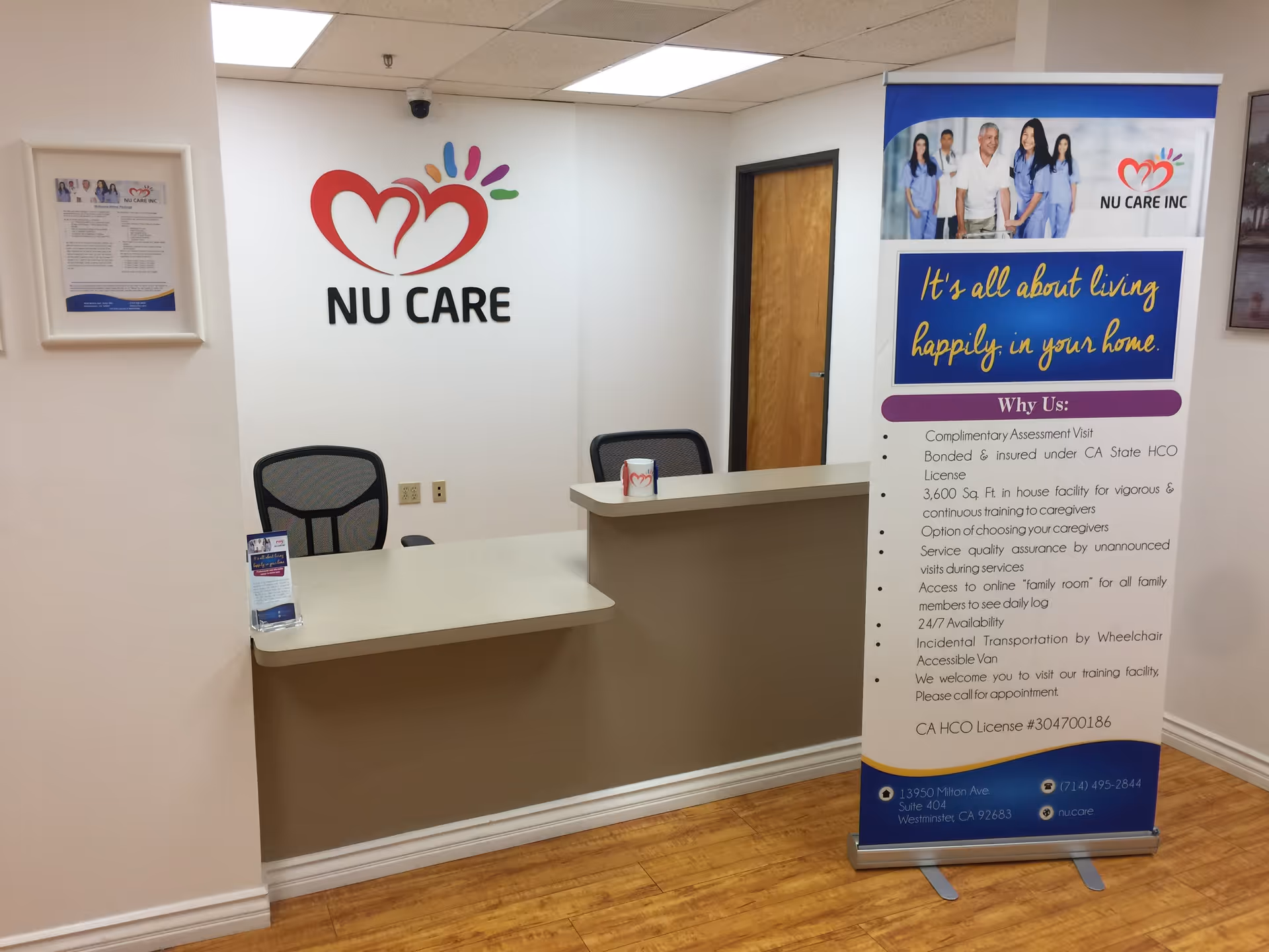 Reception area with Nu Care logo on the wall, front desk, and banner.