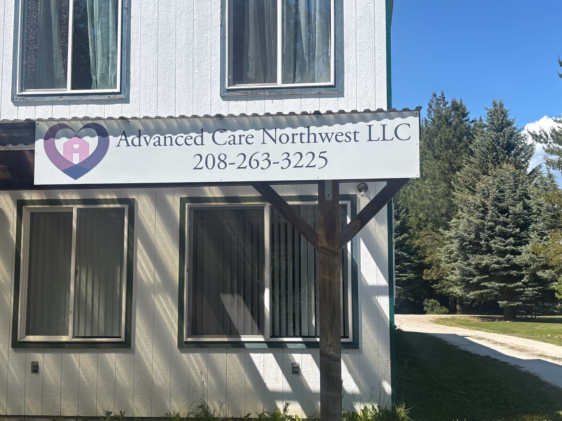 Exterior of a two-story building with Advanced Care Northwest LLC sign.