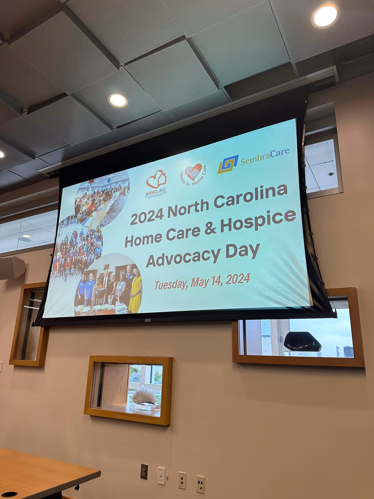 Large projection screen displays a conference banner about North Carolina Home Care & Hospice Advocacy Day